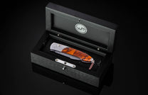 Handcrafted William Henry custom automatic knife features a titanium frame