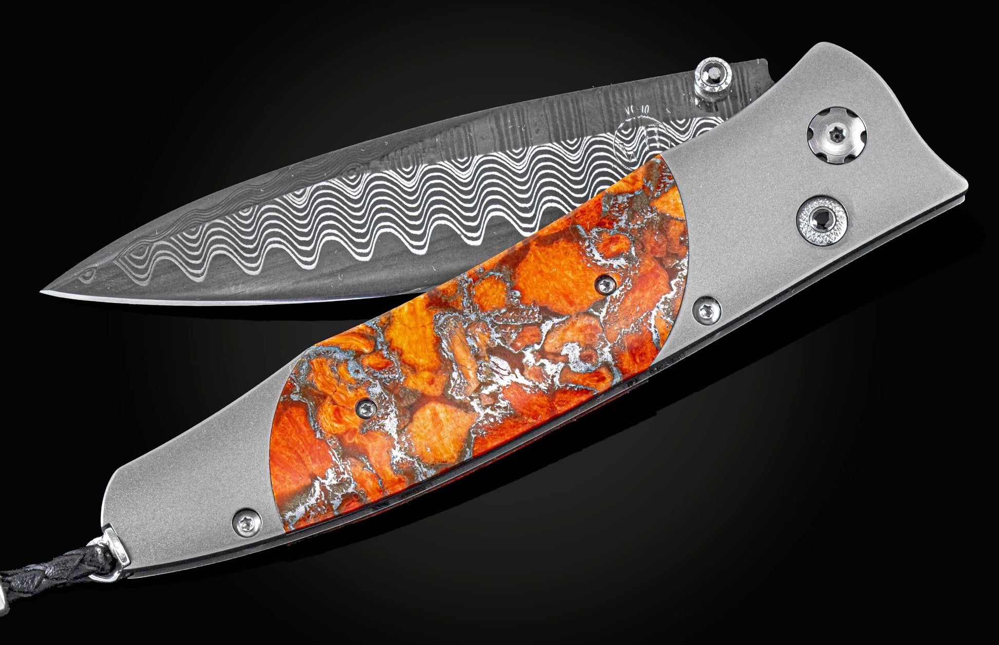 Handcrafted William Henry knife with titanium frame, inlaid with ' Zinc Matrix' apple coral, set with spinel gemstones, and a hand-forged damascus  steel blade.