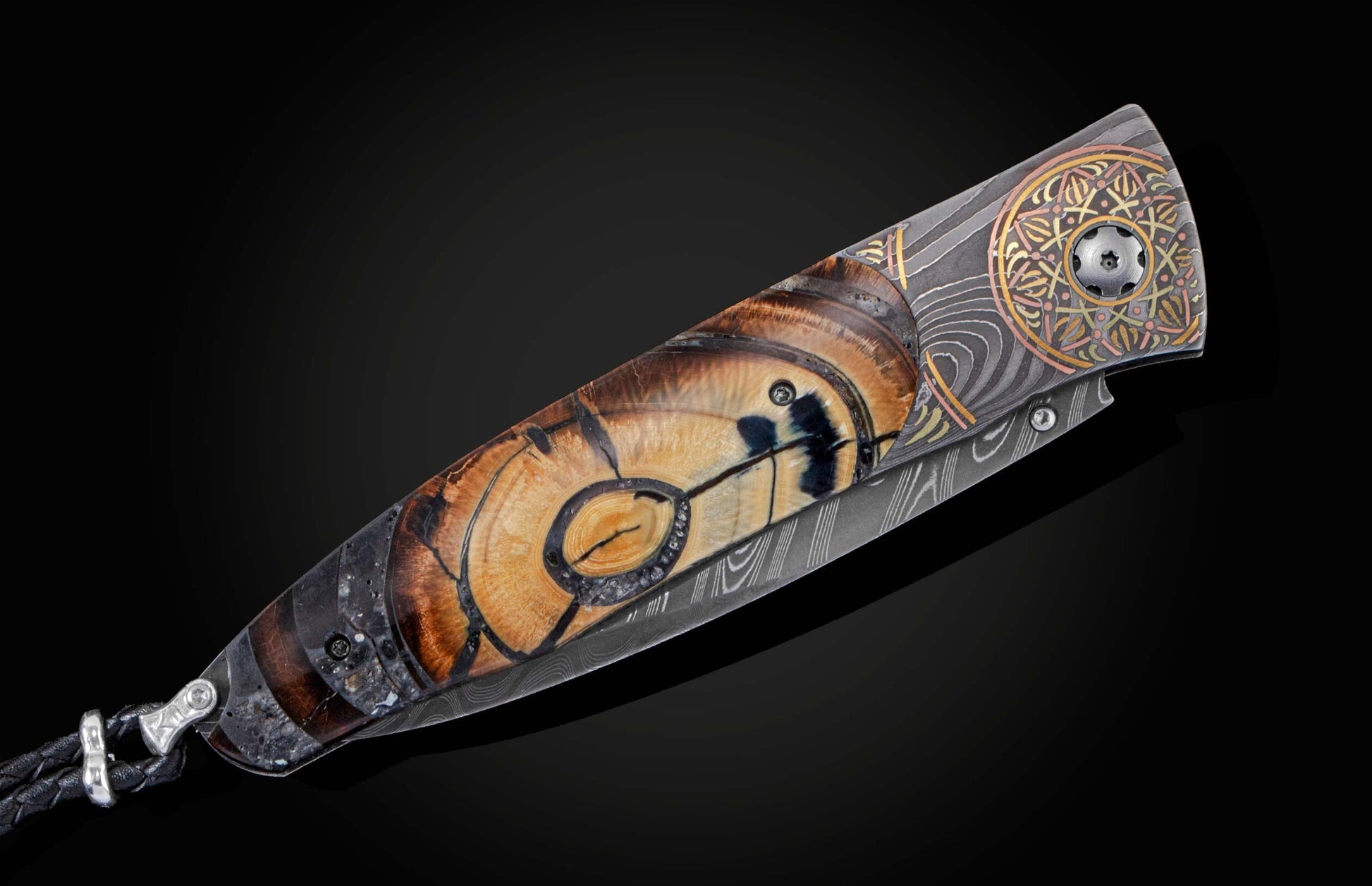 Handcrafted pocket knife from William Henry features a hand-engraved  Damascus steel frame with 24K yellow gold
