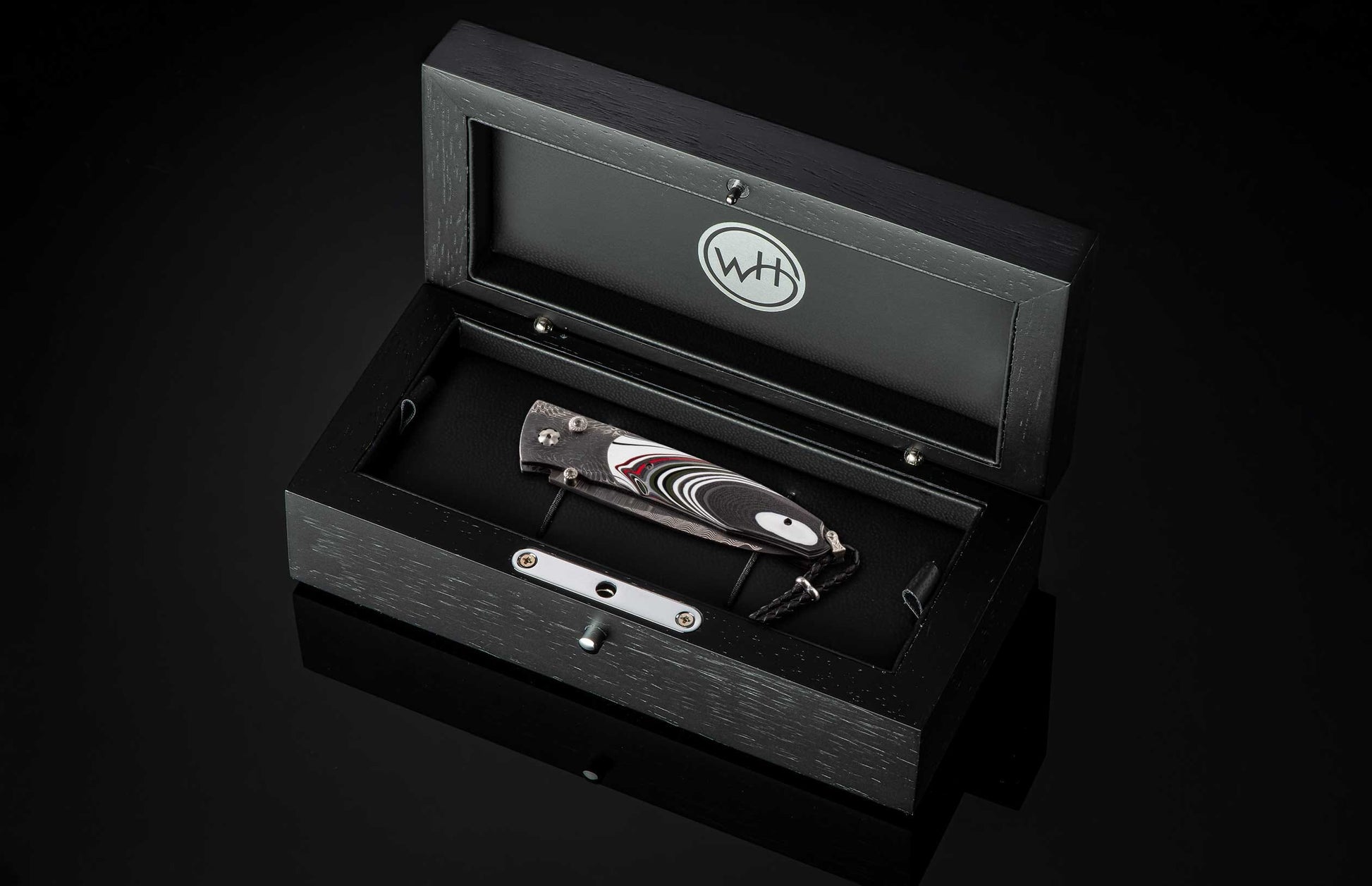 The Flathead Damascus Pocket Knife with Fordite Scales in a case