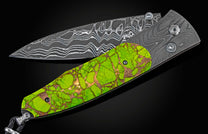 Folding knife with Damascus steel blade, vibrant green handle with bronze veins, and faceted gem accents.