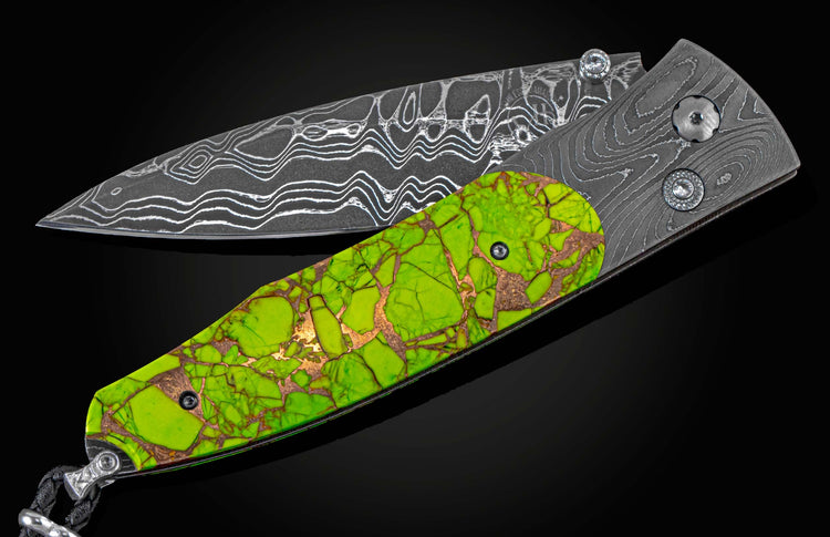 Folding knife with Damascus steel blade, vibrant green handle with bronze veins, and faceted gem accents.
