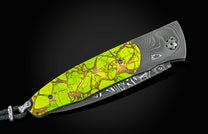 Folding knife with lime green mosaic handle, copper accents, Damascus steel blade, and black lanyard.