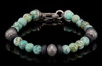 Beaded bracelet with marbled turquoise, matte black, and textured silver beads, featuring a silver toggle clasp.