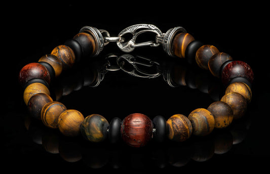 Beaded bracelet with golden-brown and dark red tiger's eye beads, matte black spacers, and a textured '925' silver clasp.