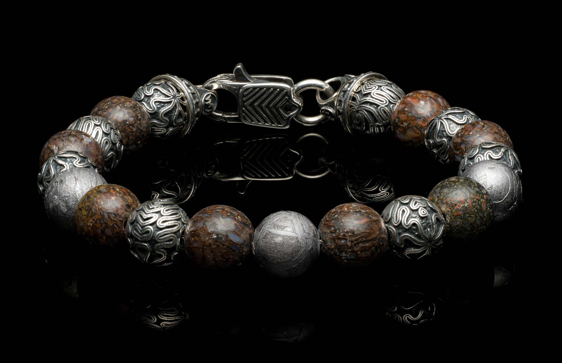 Handcrafted William Henry men's bracelet featuring dinosaur bone beads, Gibeon meteorite beads, and sculpted sterling silver beads, finished with a custom clasp.