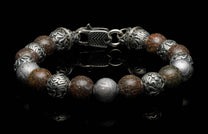 Handcrafted William Henry men's bracelet featuring dinosaur bone beads, Gibeon meteorite beads, and sculpted sterling silver beads, finished with a custom clasp.
