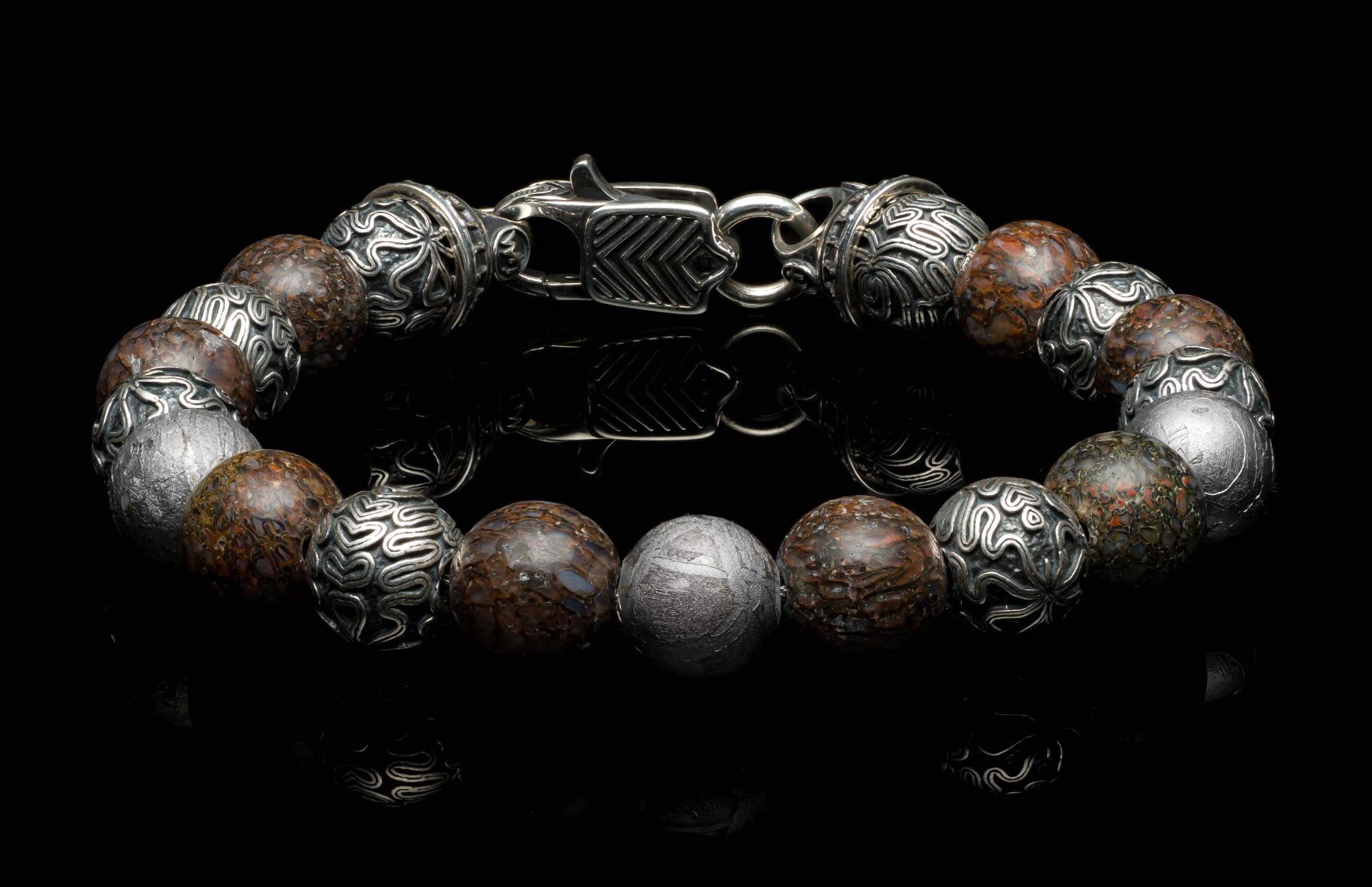 Handcrafted William Henry men's bracelet featuring dinosaur bone beads, Gibeon meteorite beads, and sculpted sterling silver beads, finished with a custom clasp.