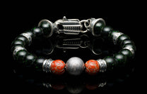 Handcrafted William Henry men's bracelet with dinosaur bone and shimmering green goldstone beads surround a singular Gibeon meteorite bead, accented with sculpted sterling silver and a custom clasp