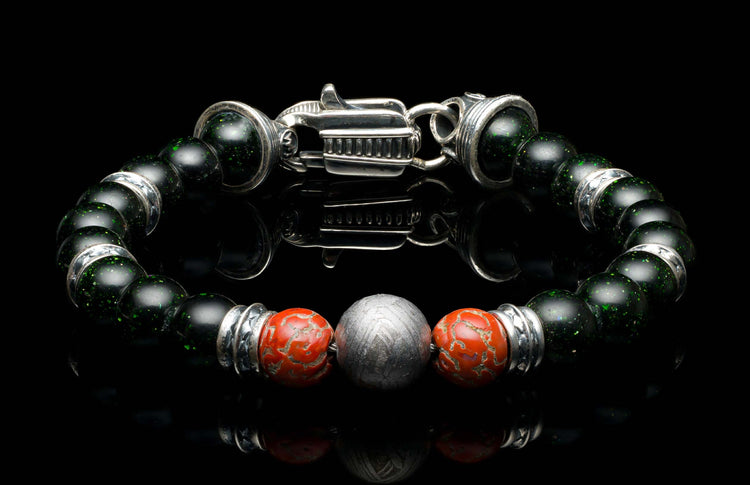 Handcrafted William Henry men's bracelet with dinosaur bone and shimmering green goldstone beads surround a singular Gibeon meteorite bead, accented with sculpted sterling silver and a custom clasp