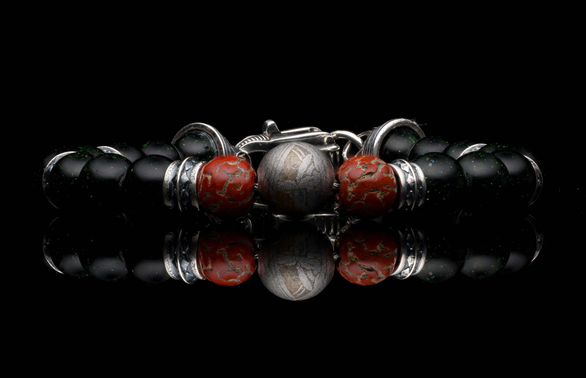 Handcrafted William Henry men's bracelet with dinosaur bone and shimmering green goldstone beads surround a singular Gibeon meteorite bead