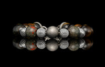 Beaded bracelet with meteorite, dinosaur bone, and Tiger's Eye beads
