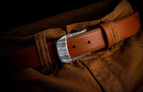Handcrafted designer belt buckle from William Henry in solid sterling silver inlayed with blue Woolly Mammoth Tooth.  Each inlay is hand-polished from a slice of the molar tooth of the Wooly Mammoth.