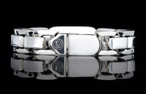 Polished sterling silver link bracelet with interlocking rectangular links, a decorative clasp emblem, and '925' stamp.