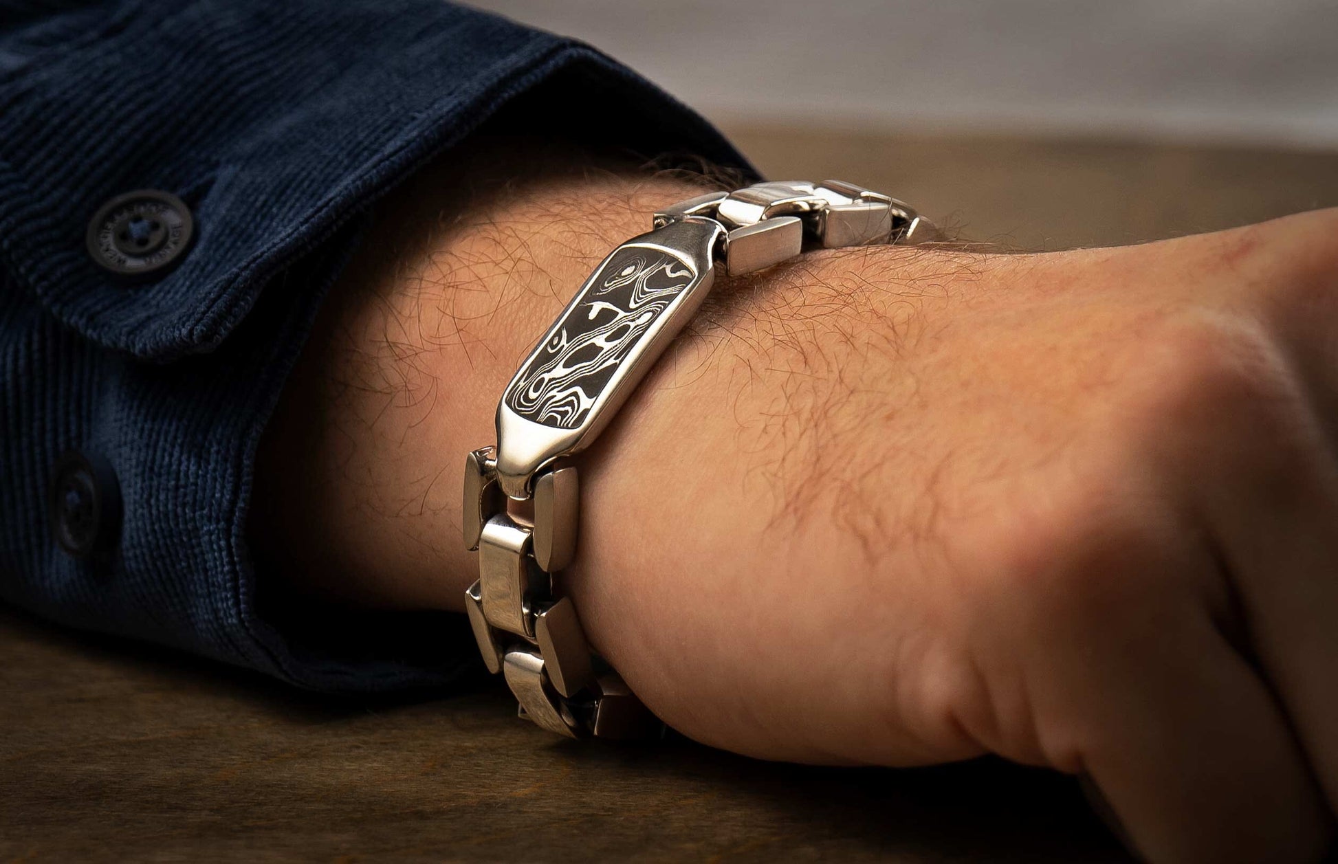 The Damascus Identity Sterling Silver Bracelet with Hand-Forged Damascus on a wrist