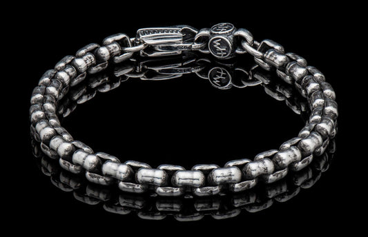 Silver YDRA link bracelet with hammered texture and a clasp stamped '925' and stylized logo.