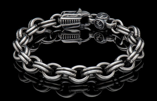 Silver chain bracelet with a dragon head clasp and HW initial charm, reflecting on a black surface.