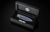Handcrafted pocket knife from William Henry with a titanium frame that is anodized blue