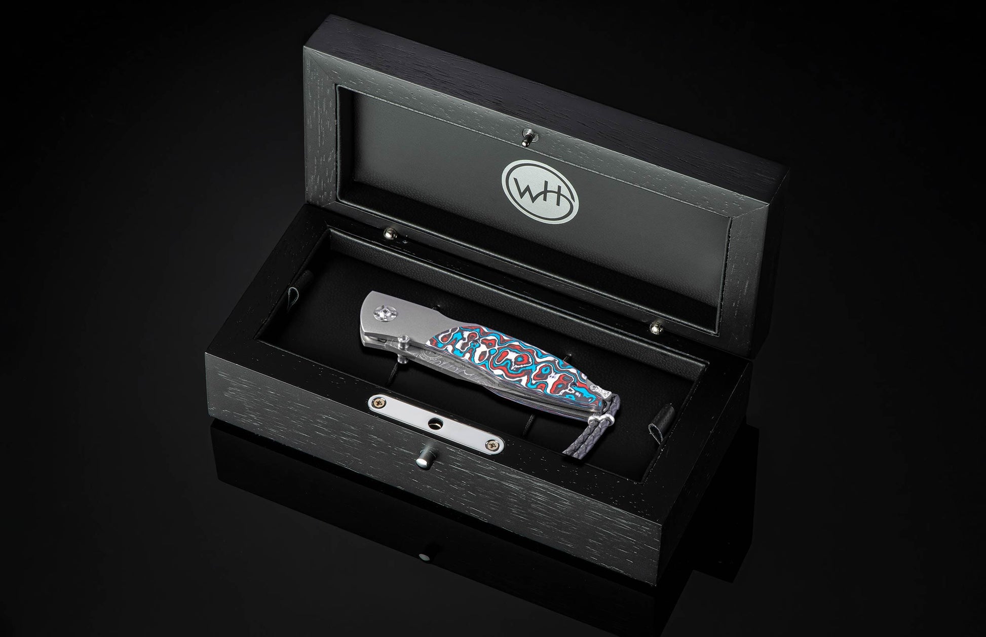  and a is hand-forged 'Intrepid' damascus steel blade by Chad Nichols.