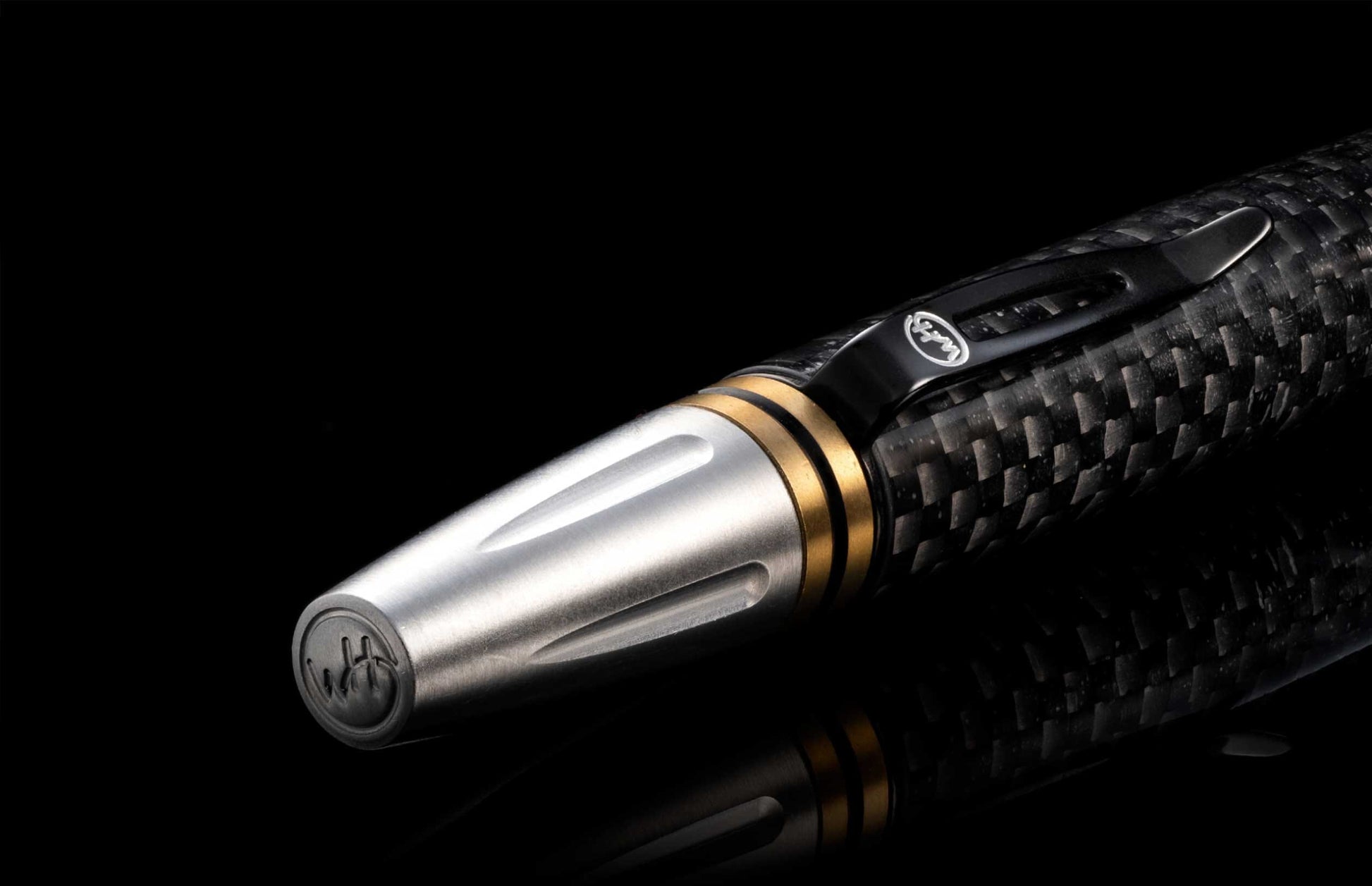  and the tip and top section are crafted from stainless steel with art deco details. The pen is displayed on a black background.