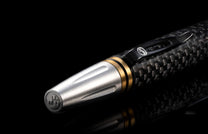  and the tip and top section are crafted from stainless steel with art deco details. The pen is displayed on a black background.