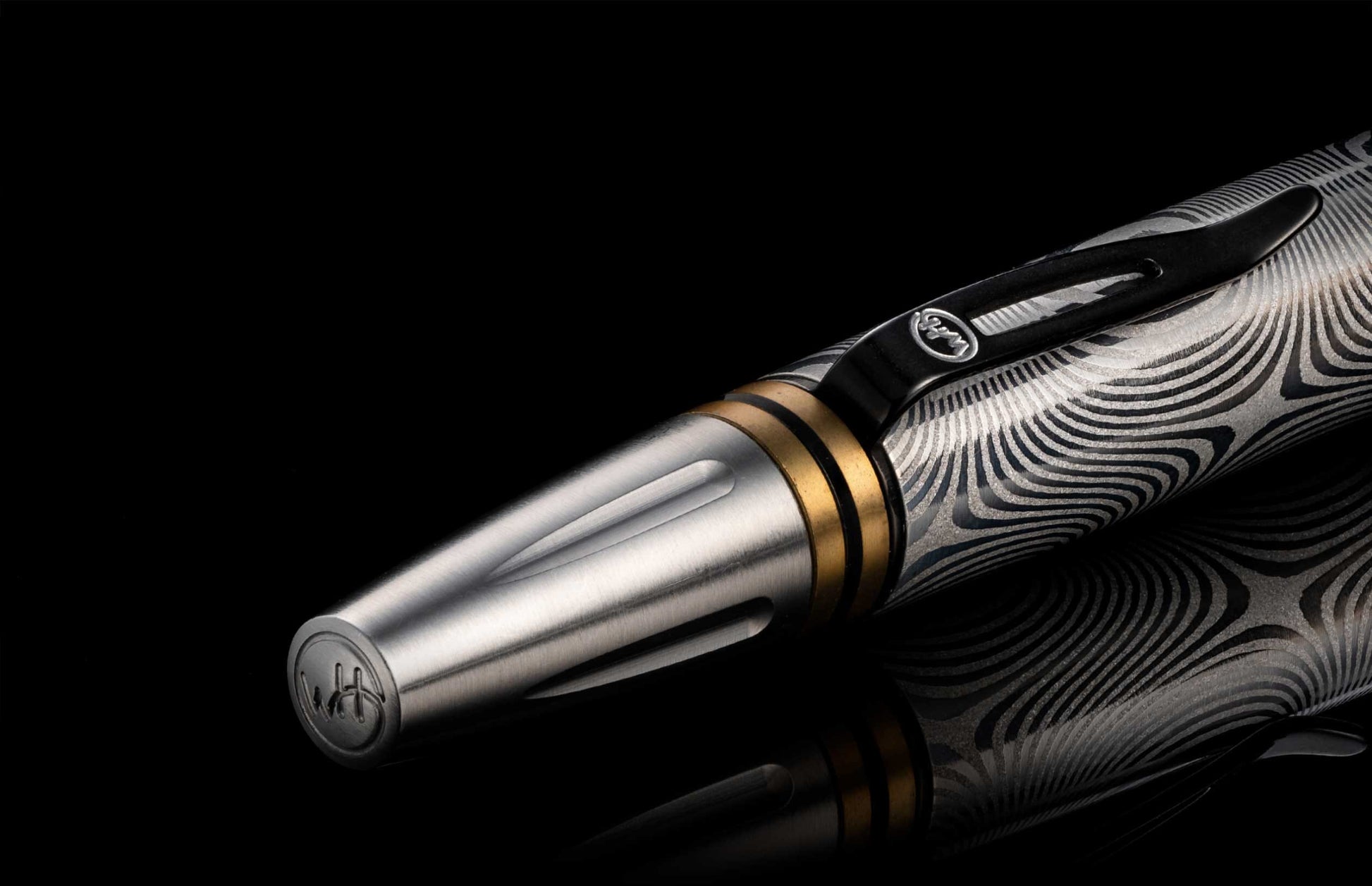  and the tip and top section are crafted from stainless steel with art deco details. The pen is displayed on a black background