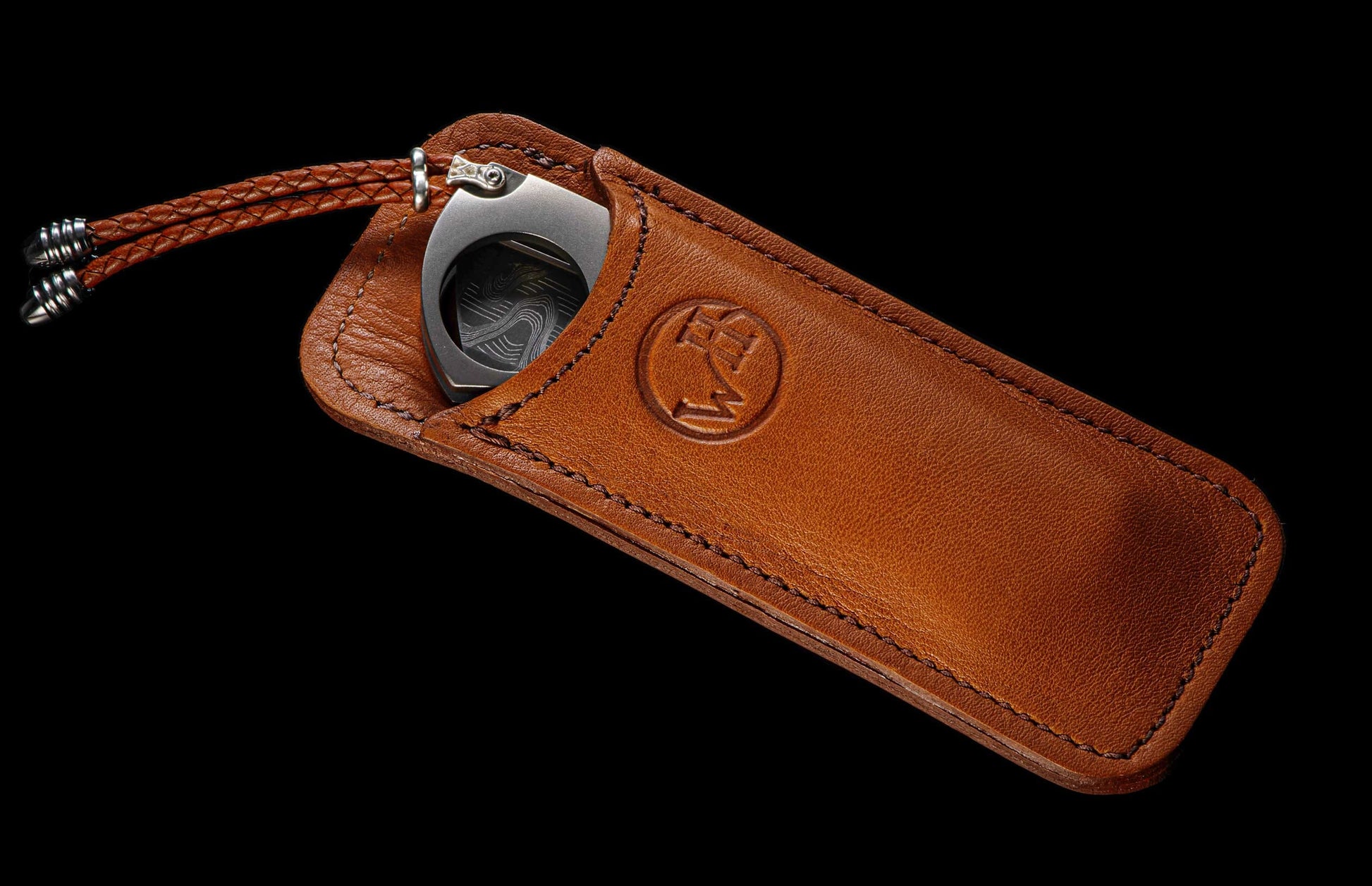 The Titanium Cigar Cutter with Fossil Mammoth Tooth and Damascus Blade in a leather case
