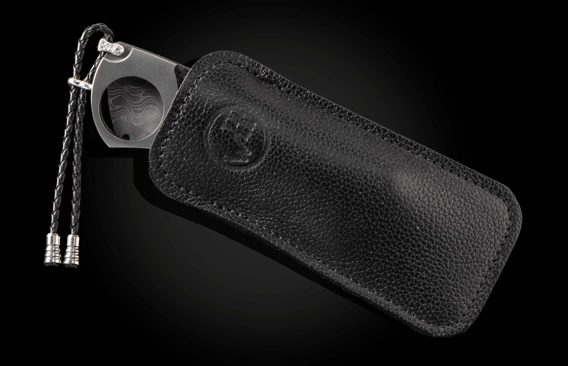 A Carbon Fiber Cigar Cutter in a leather case