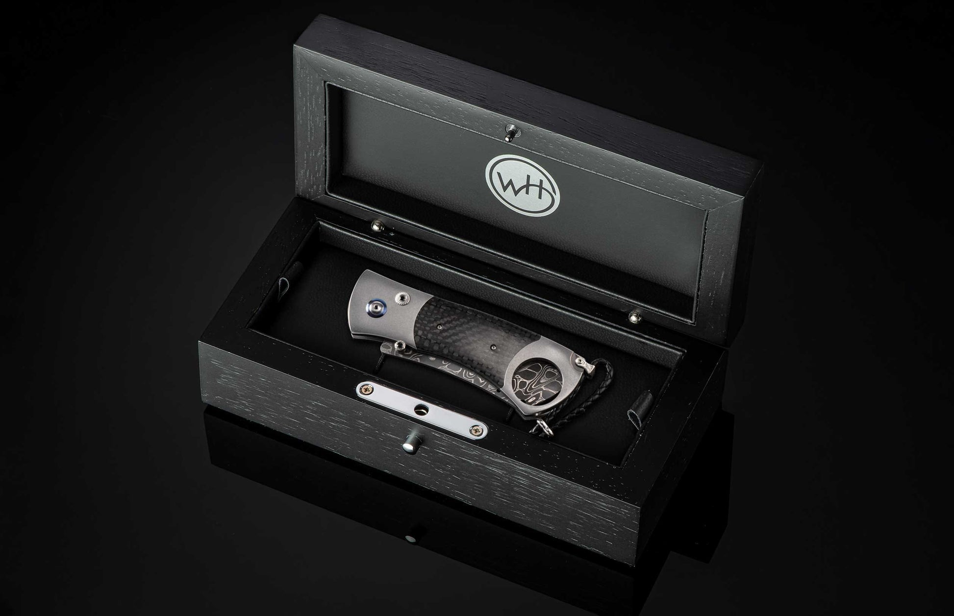 A Carbon Fiber Cigar Cutter in a case