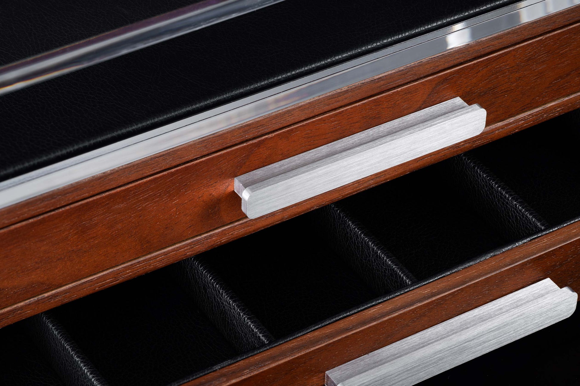 Wooden display case with silver handles on a black background