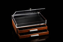 Wooden knife display case with clear acrylic top on a black background