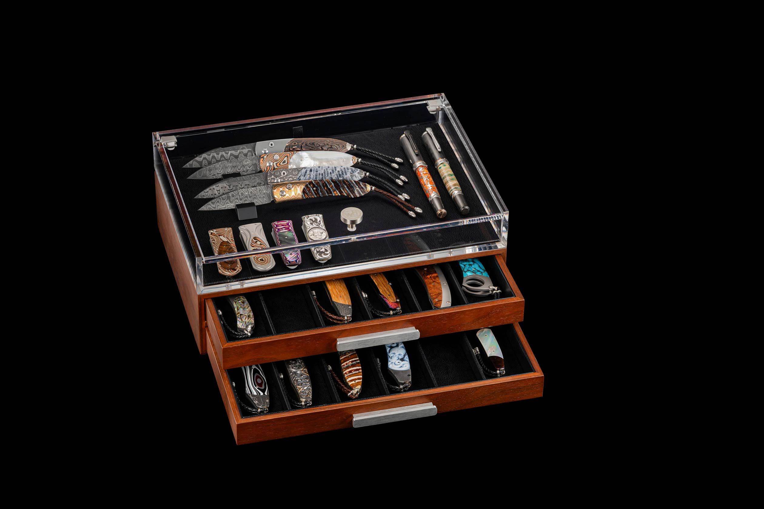 Wooden knife display case with various knives on a black background