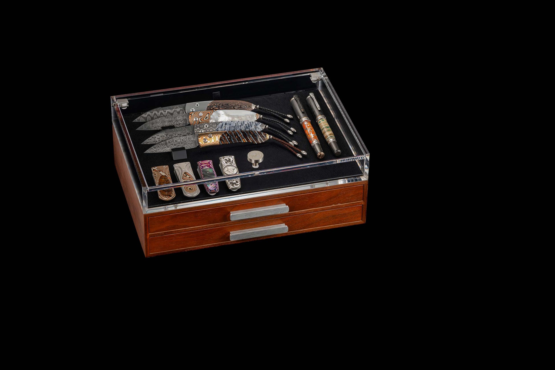 Collection of knives in a wooden display case on a black background