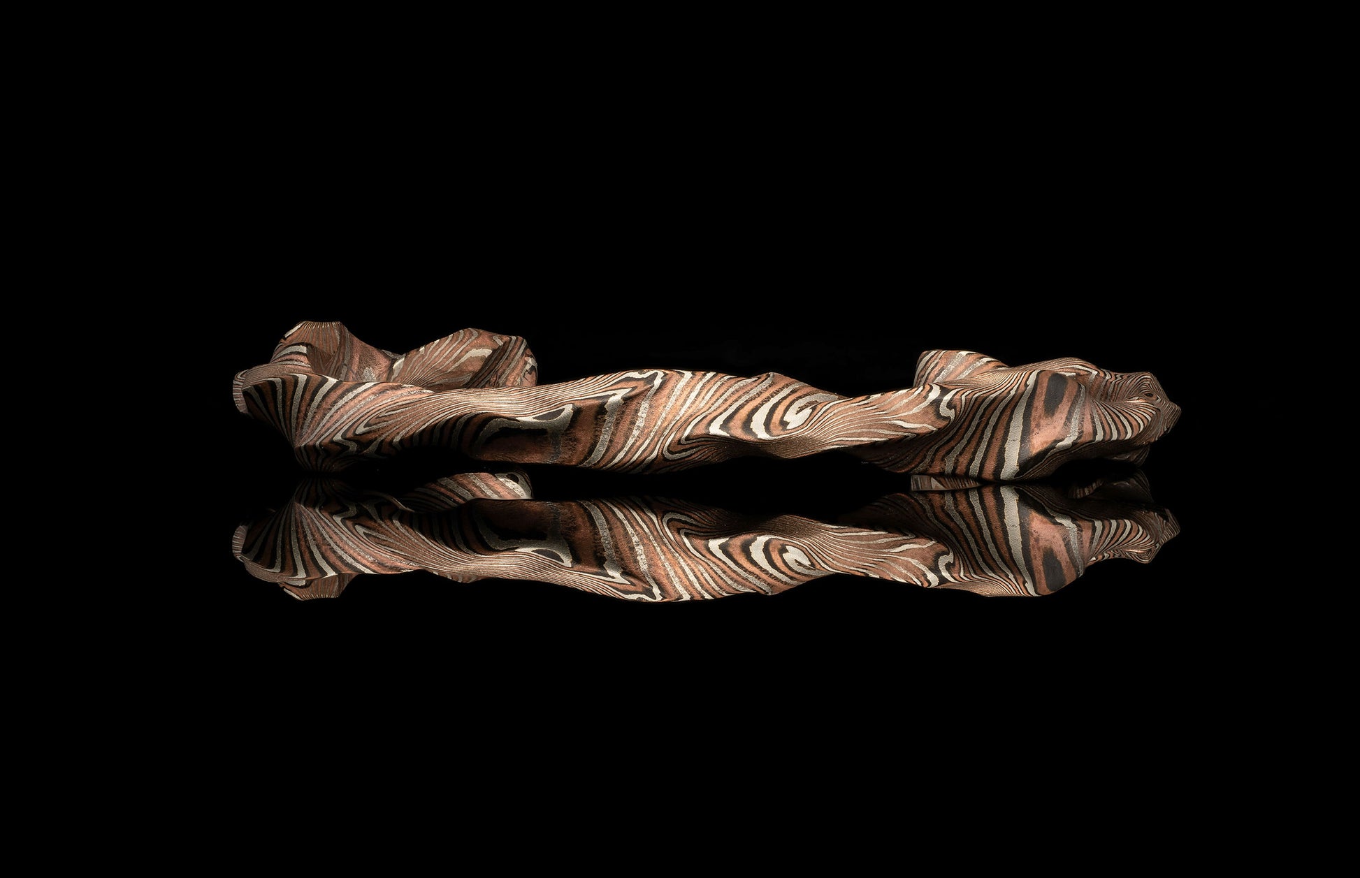 bracelet with wavy design on a black background