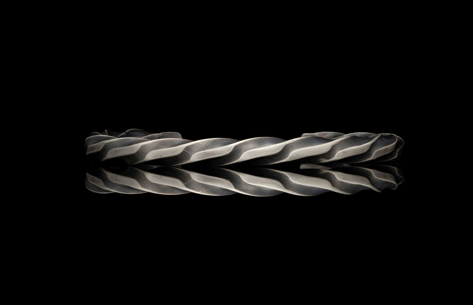 Metallic twisted bar on a black background