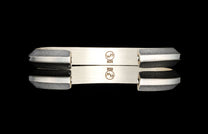 Silver HC9 Keystone bracelet with textured ends and smooth center, marked 925, displayed with reflection.