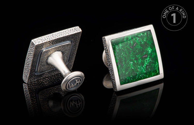 Square silver cufflinks with a green stone and textured metal back, featuring WH initials.