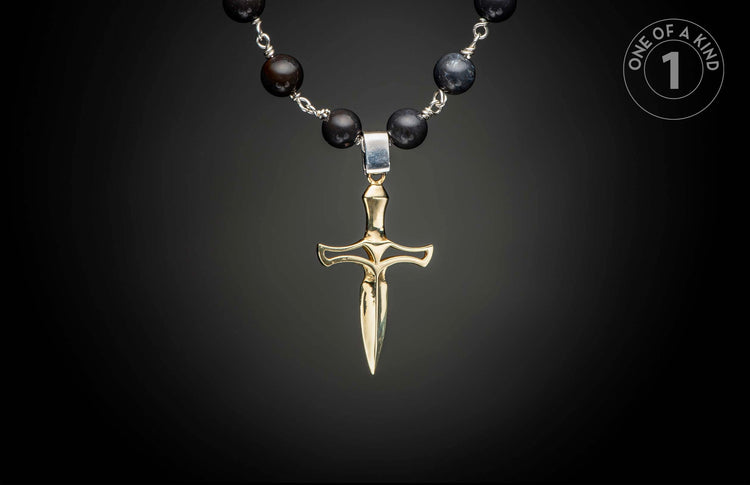 Gold-toned dagger pendant on a dark beaded necklace with silver wire connections.
