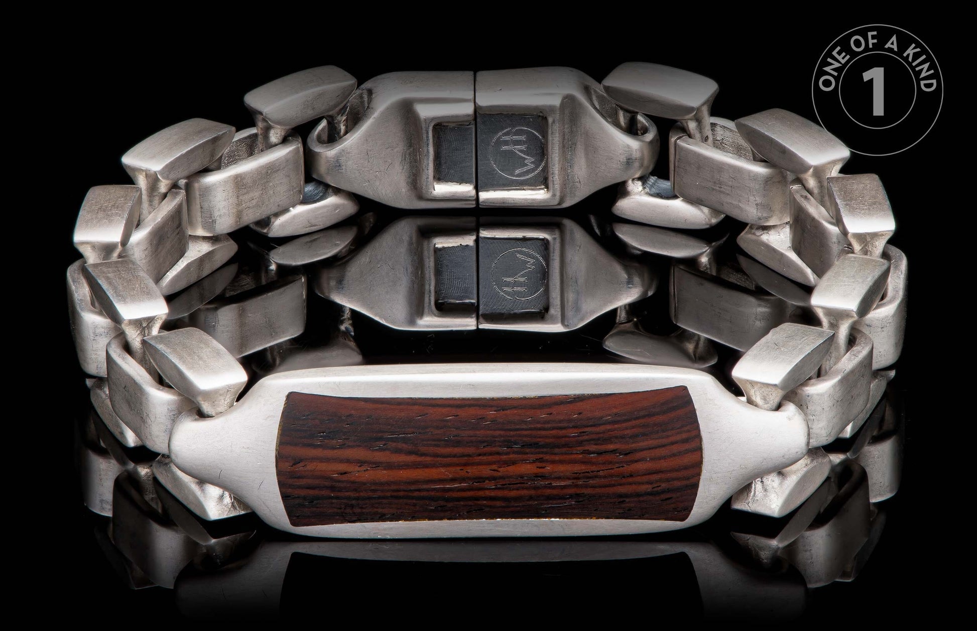 Silver bracelet with dark wood inlay, featuring interlocking links and a reflective black background.