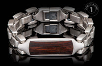 Silver bracelet with dark wood inlay, featuring interlocking links and a reflective black background.