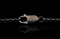 Sterling silver chain necklace with an HW logo lobster clasp and 925 mark, reflected below.