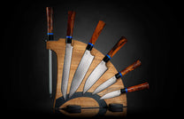 K20-IRM|Gourmet Chef Knives Set by Kultro with reddish-brown wood handles, blue accents, and patterned blades, on a wooden display block with sharpening rod.