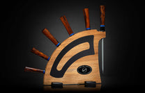 K20-IRM|A set of chef knives with dark wood handles by William Henry, displayed in a light wood block with black and blue accents.