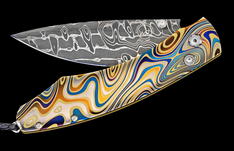 One of a kind William Henry custom knife with Damascus steel, Laser color-engraved titanium, and White topaz gemstones.