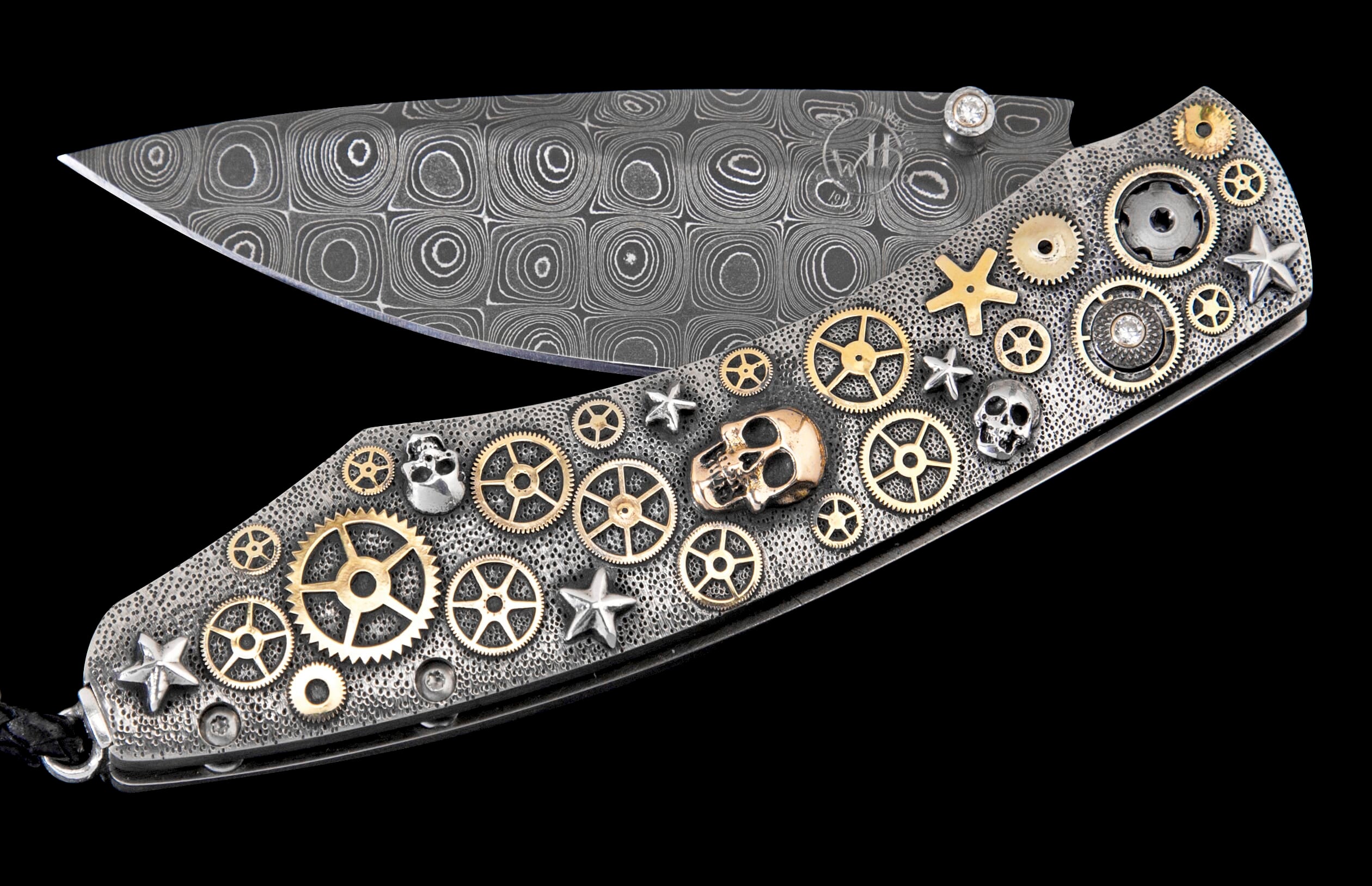 Ornate folding knife with a patterned Damascus steel blade and a textured handle adorned with brass gears, silver stars, skulls, and diamonds.