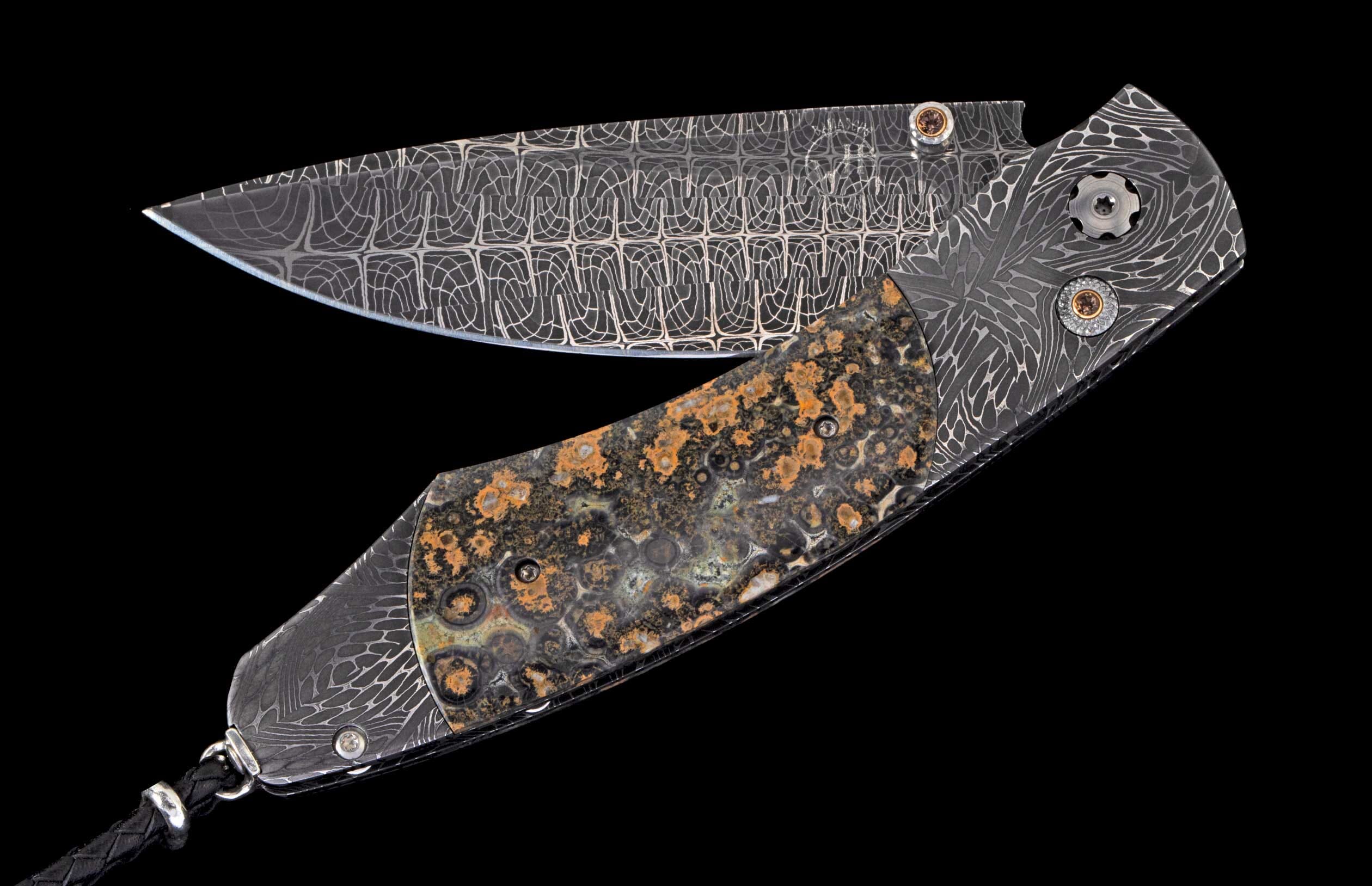 Ornate folding knife with a geometric patterned Damascus blade and a mottled dark stone handle.