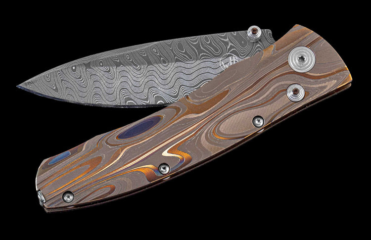 William Henry pocket knife featuring Laser color-engraved titanium frame and hand forged damascus steel blade