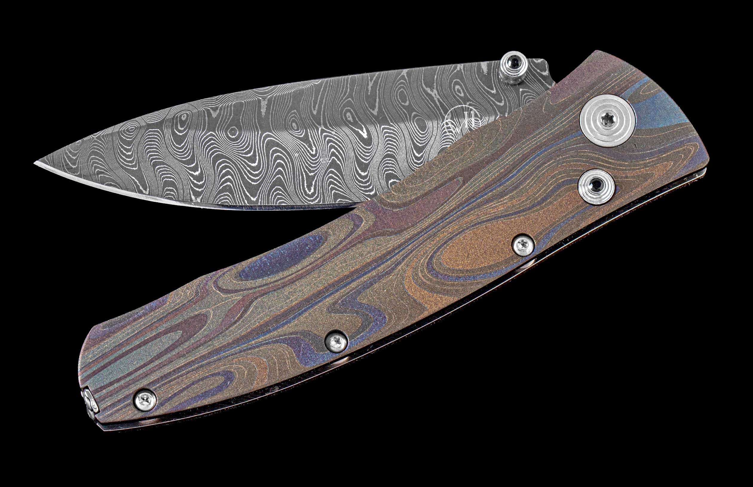 One of a kind  hand-crafted pocket knife from William Henry featuring a Laser color-engraved titanium frame and damascus steel blade