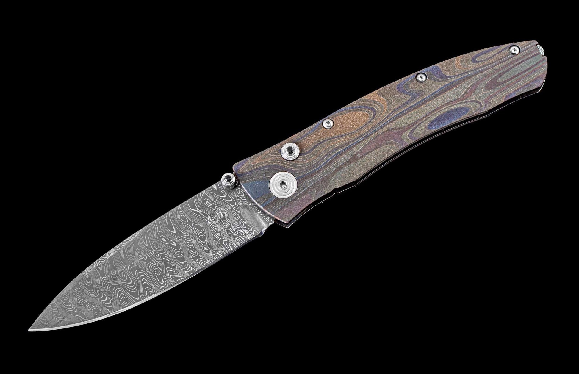 One of a kind  hand-crafted pocket knife from William Henry featuring a Laser color-engraved titanium frame and damascus steel blade
