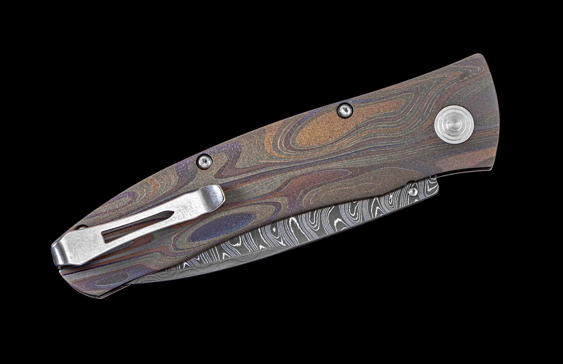 One of a kind  hand-crafted pocket knife from William Henry featuring a Laser color-engraved titanium frame and damascus steel blade